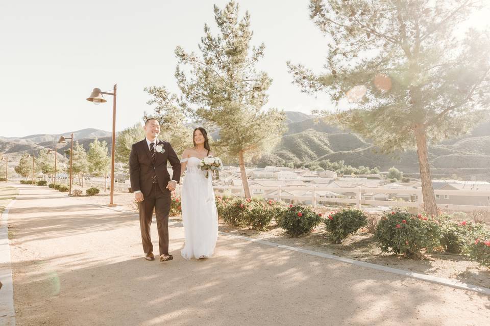 Newlyweds walk thru the park