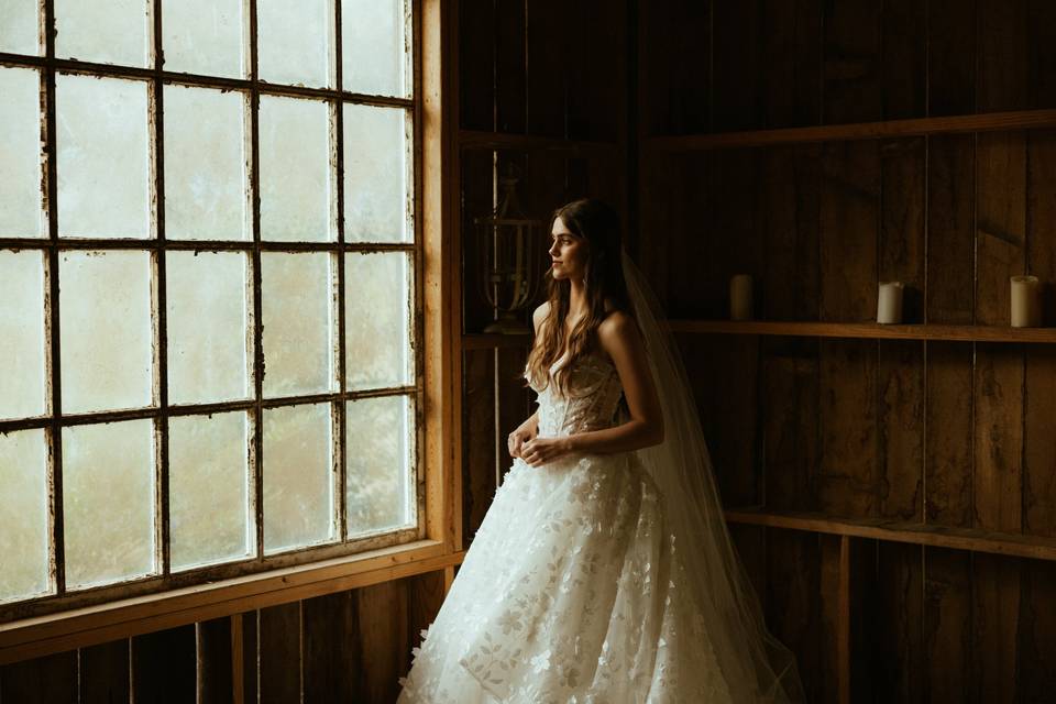 Bride looking out glass window