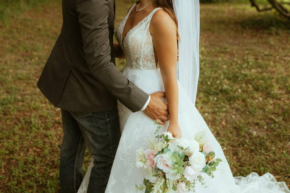 Bride & groom under oaks