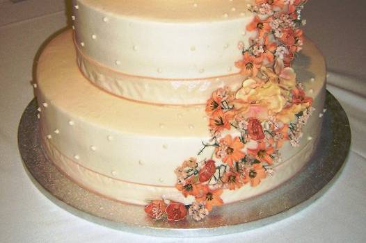 3 tier round peach with ribbon and cascading flowers
