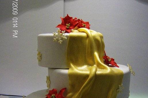 3 tier round with gold draping, pointsettas and snowflakes