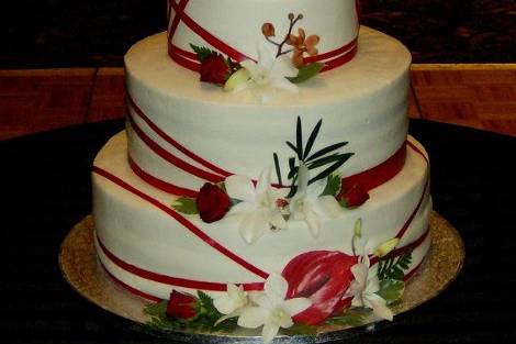3 tier with thin red ribbon and woodsy flower accents