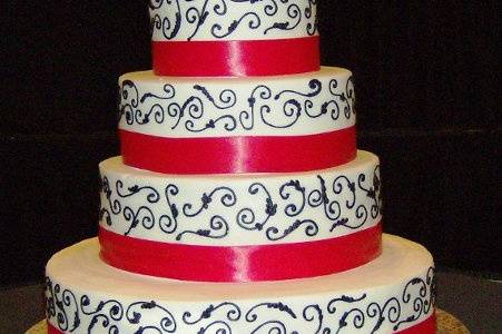 4 tier with pink ribbon and black swirls