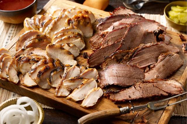 Hand-slices slow-cooked meat