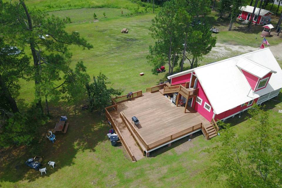 Aerial view of restored century old farmhouse and deck
