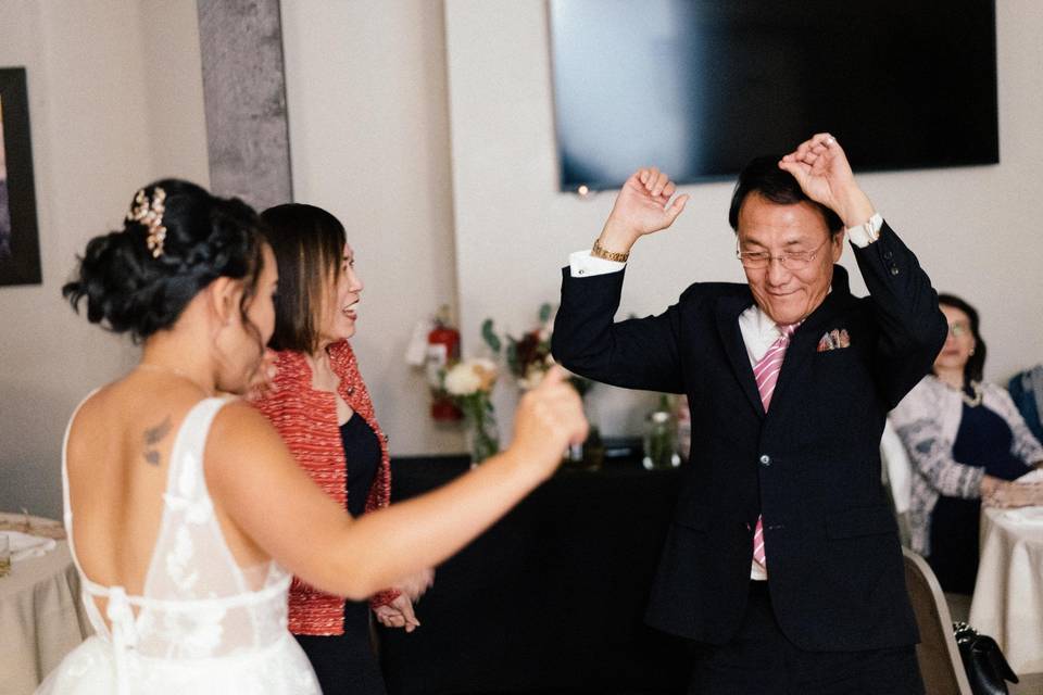 Bride dancing with parents