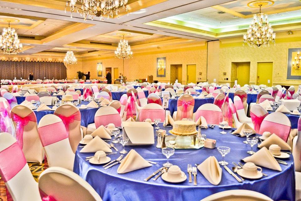 Ivory Spandex Chair Covers, Royal Blue Satin Table Overlays, & Fuchsia Organza Sashes