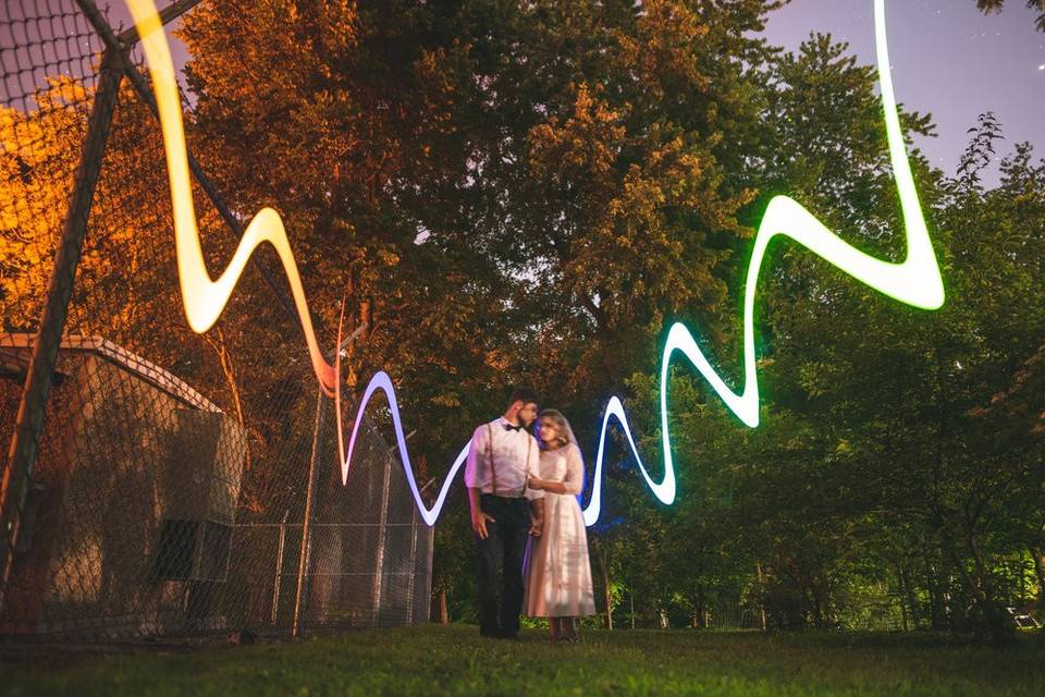 Bride and groom flanked by lights - Bryson Buehrer Photography