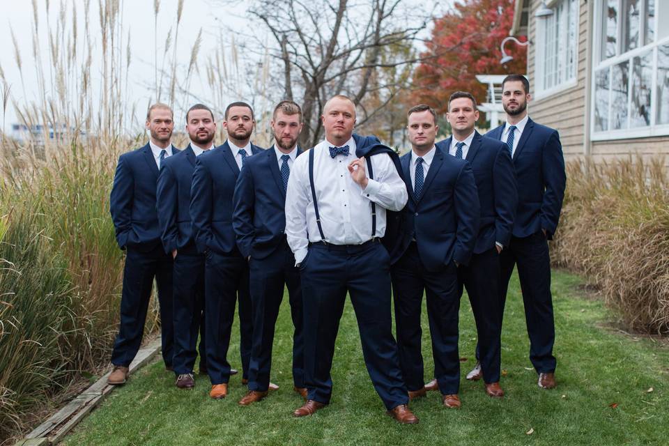 The groom and his groomsmen outdoors