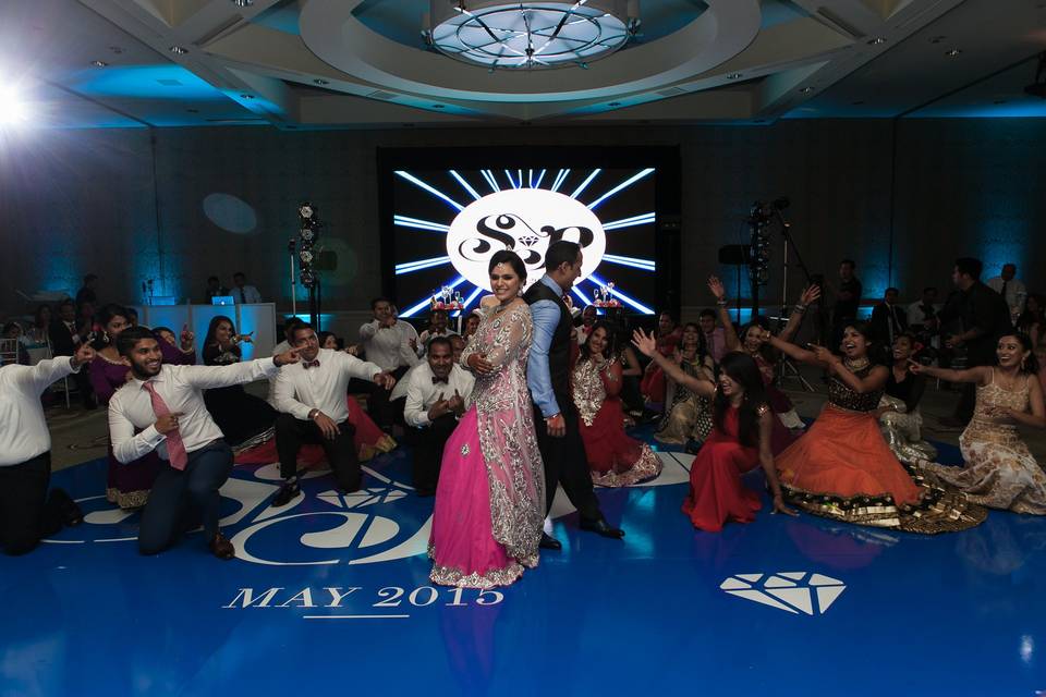 Couple dancing with their groomsmen and bridesmaids