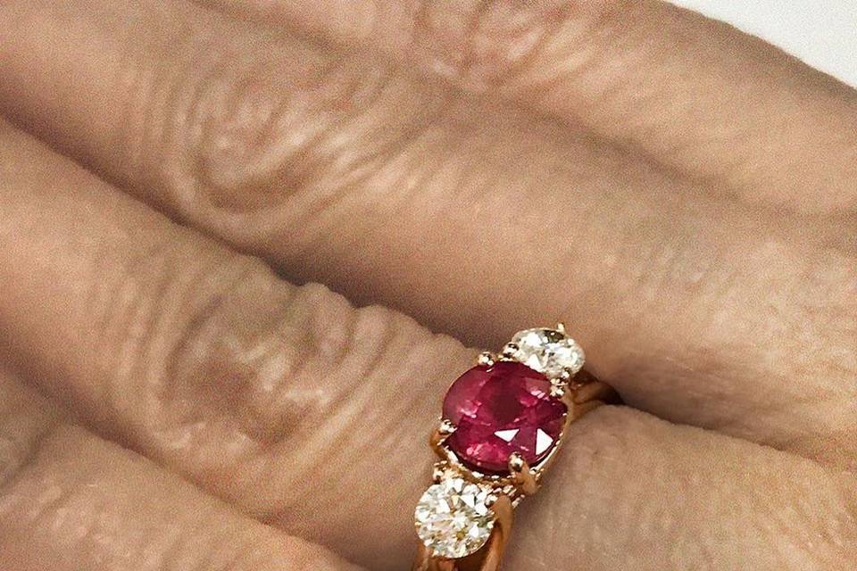 Sparkling ruby and diamond three-stone ring