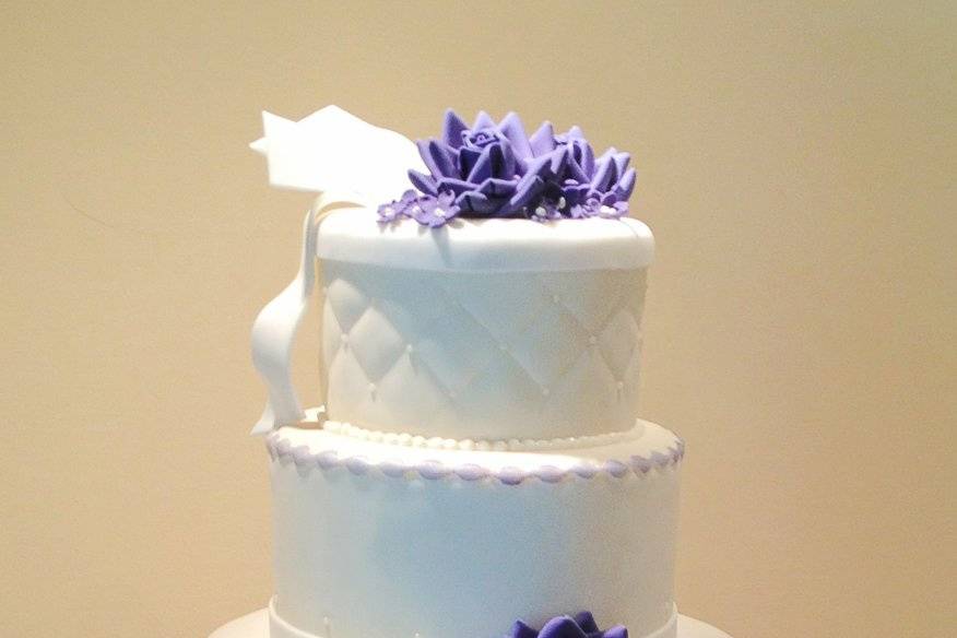 Four tier cake with purple flowers