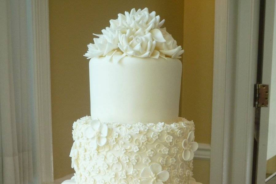 Three tier cake with white flowers