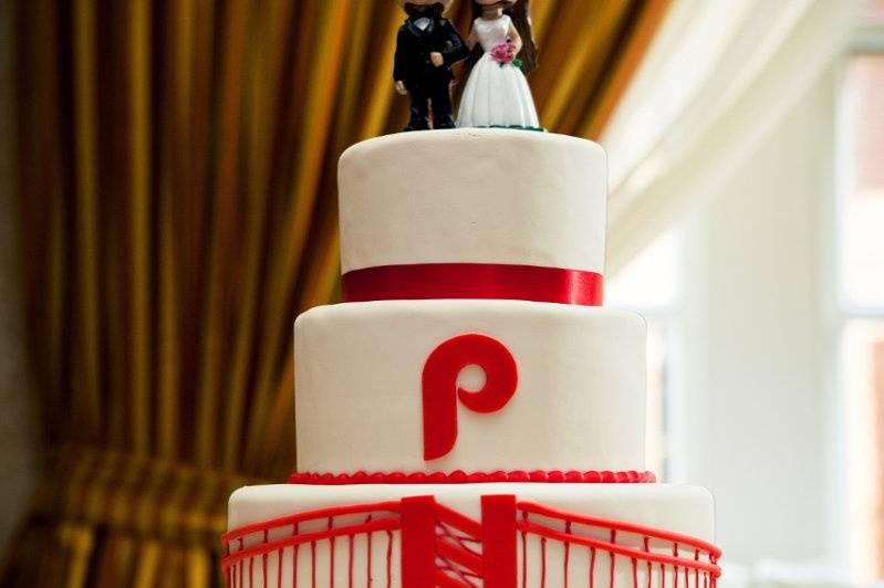 Four tier white and red wedding cake