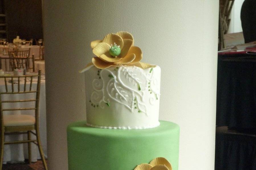 White and green cake with gold flowers