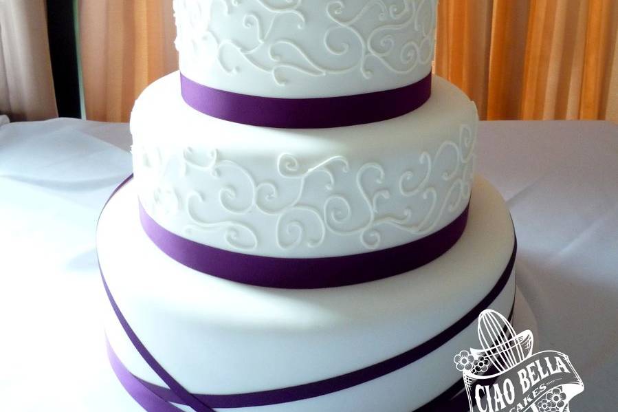 Four tier purple and white cake