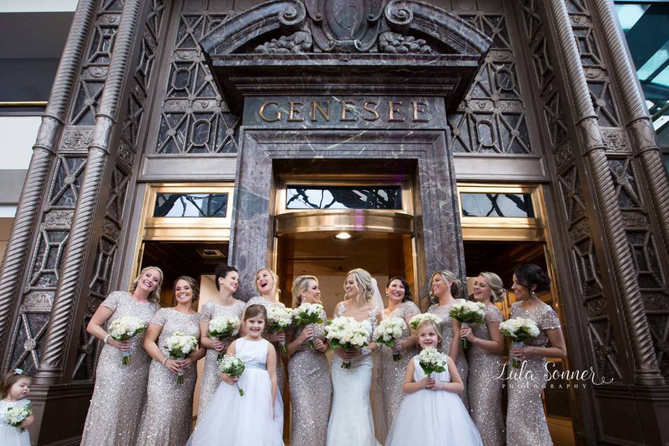 Bride with her bridesmaids at venue entrance