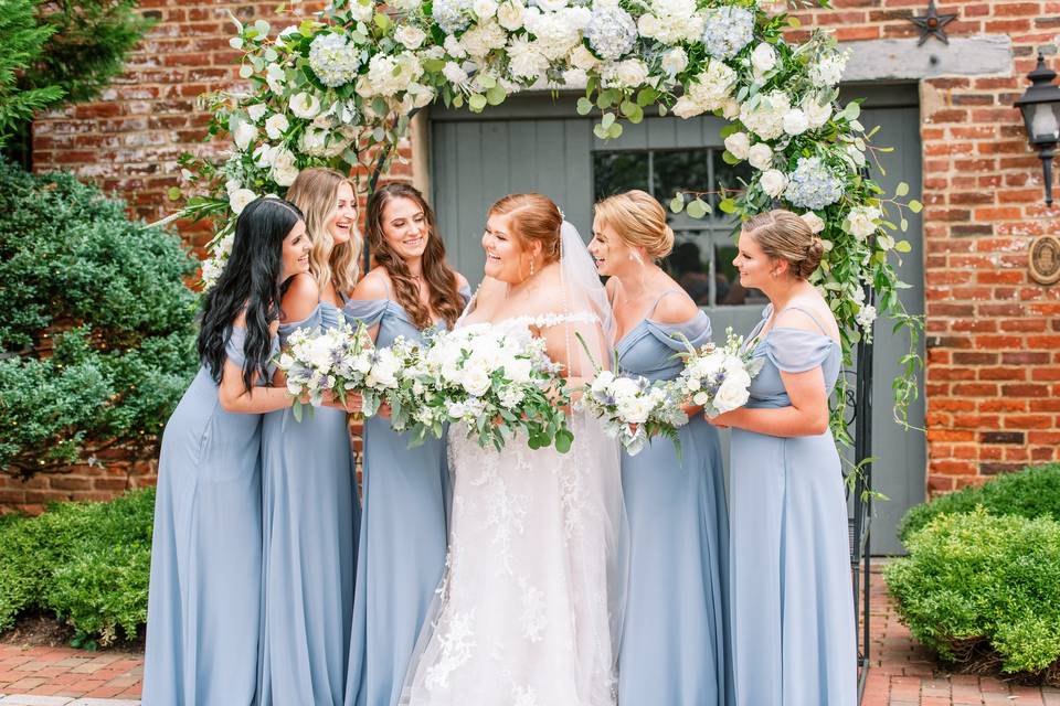 Bridal party in front of arch