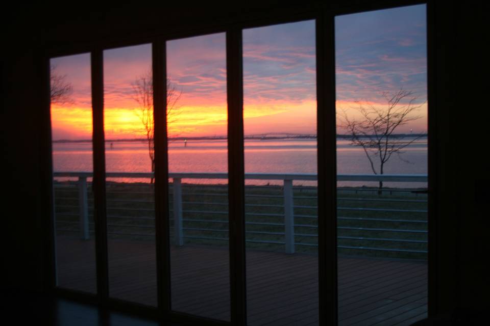 View of awesome sunset through one of the two large folding doors, opening up completely to the River deck.