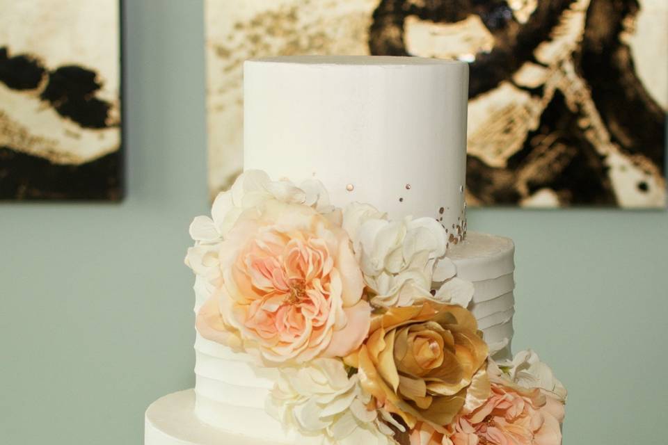 Peach flowers decorating three tier cake