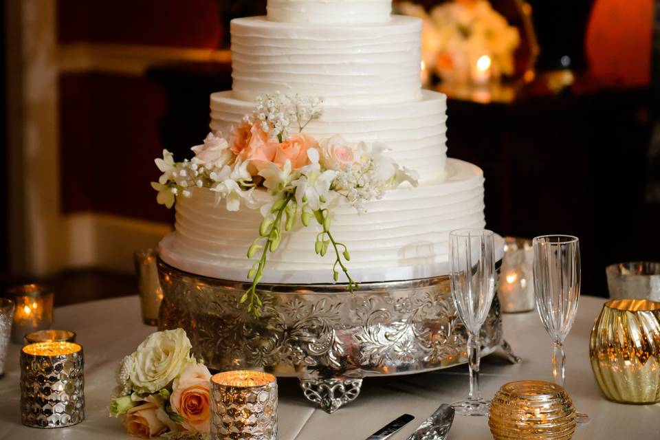 Peach flowers decorating three tier cake