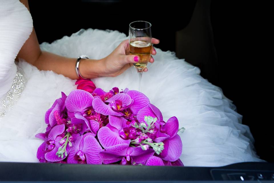 Phalaenopsis orchids in this mass arrangement are over the top beautiful! The handle of the bouquet is completely wrapped so that it won't pick the textured skirt of the wedding dress.