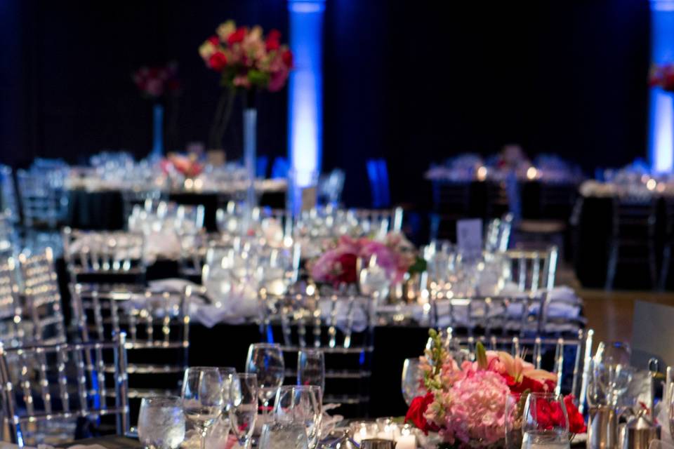 The elegant room dramatic with the black linen and colorful centerpieces.