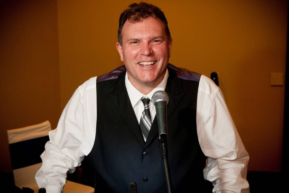 Jonny has enjoyed doing weddings for over 20 years, but you’re more likely to know Jonny from the radio. Currently Jonny does wake up duties on WWSW (94.5/3WS) from 5am to 10am each weekday morning.
In radio circles, Jonny has earned the nick-name of “Jonny Palooza” for his passion for fun, games and good times! Jonny will bring the same energy and enthusiasm he has on the radio to your event or wedding reception.
Although, Jonny plays “classic hits” on the radio, he is well versed in many genres of music-Top 40, Dance, even Country! He also has the proud distinction of being the DJ for the TLC show Four Weddings when they filmed here in Pittsburgh.
In addition to radio and weddings, Jonny has also emceed hundreds of corporate, charitable and business related events. Even though Jonny likes to keep things light, he’s also professional enough to take your event very seriously.