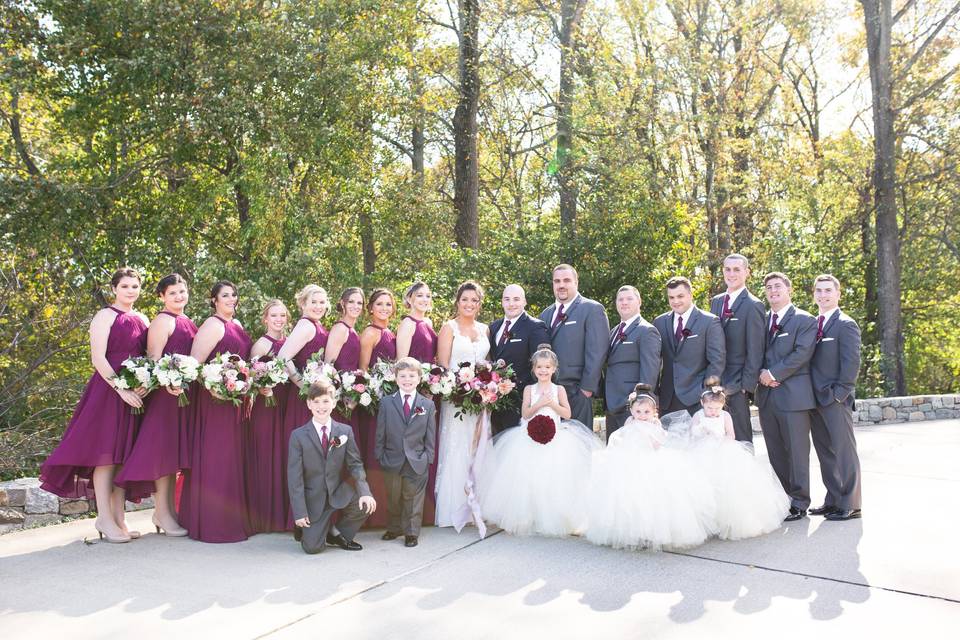 Couple with bridesmaids, flower girls and groomsmen