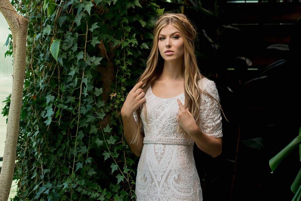 Tr11833soft allover embroidered and beaded lace sheath with elbow-length sleeves, scoop neckline, center back hidden zipper. Sizes0 - 20, 18w - 26wcolors: ivory/champagne, ivory, white