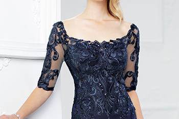 217937satin and lace mermaid gown with illusion lace three-quarter length sleeves, front and back wide scoop necklines, lace bodice with sequin accents and slightly dropped waist, sweep train. Sizes 4 – 20, 16w – 26w colorsnavy blue, brick, silver