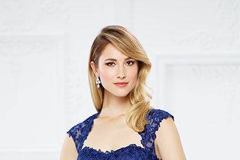 217934lace and tulle fit and flare gown with cap sleeves, soft queen anne neckline, lace bodice with dropped waist, illusion lace back with large keyhole, tulle overlay skirt with lace appliqués and three-dimensional flower accents, sweep train. Sizes 4 – 20 colorssapphire, merlot, mink