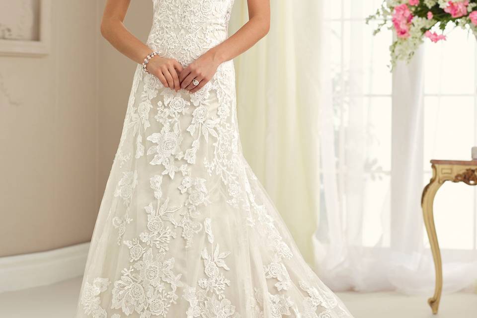 Strapless tulle, lace appliqué, and satin slim a-line gown with scalloped sweetheart neckline, hand-beaded bodice, illusion lace back with crystal buttons, chapel length train. Removable straps included. Sizes 0 – 20colors ivory/oyster, ivory, white