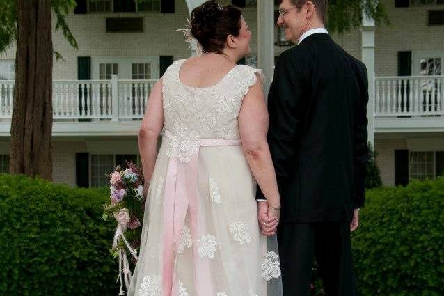 Bride leaning on her groom