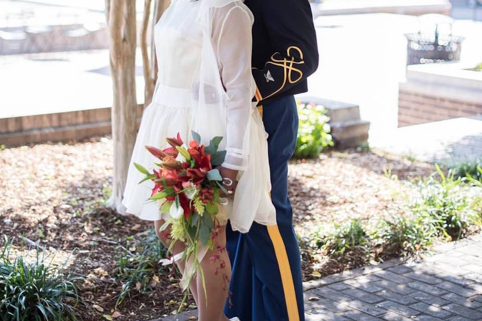 Newlyweds kissing by the tree