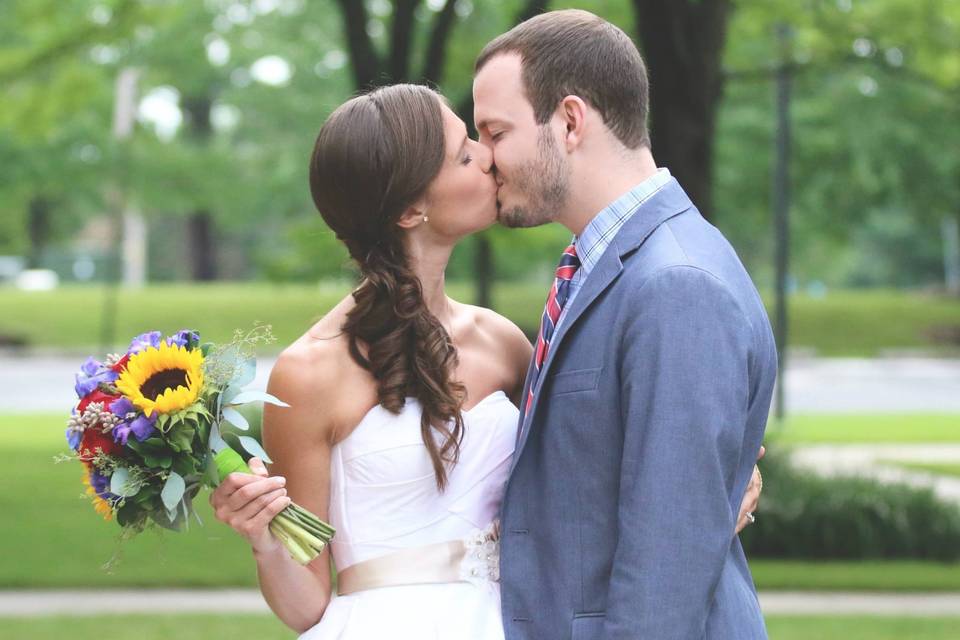 Bride wearing her groom's cap