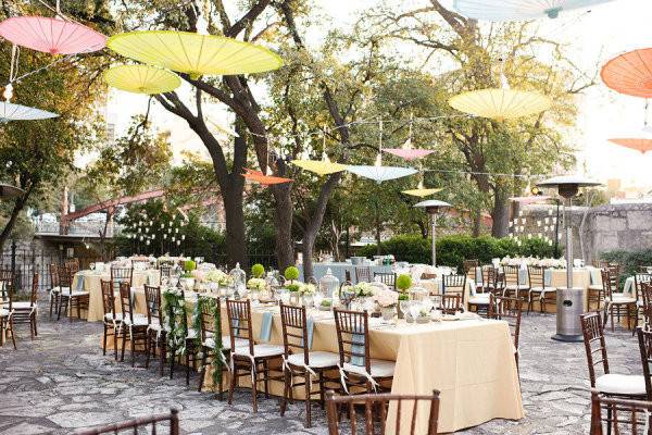 Dinner area with parasols hanging as decor and lighting