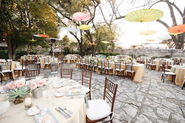 Dinner area with parasols hanging as decor and lighting