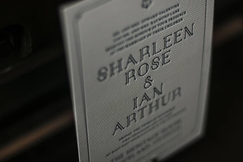 Letterpress wedding invitation with distinct typography and blind embossed pattern