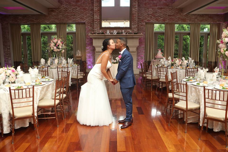 Newlyweds kissing at their reception