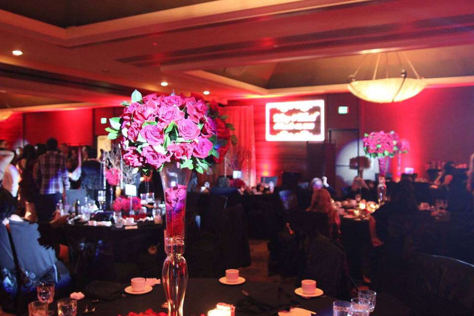 Red rose centerpiece, red uplighting, custom monogram projections.