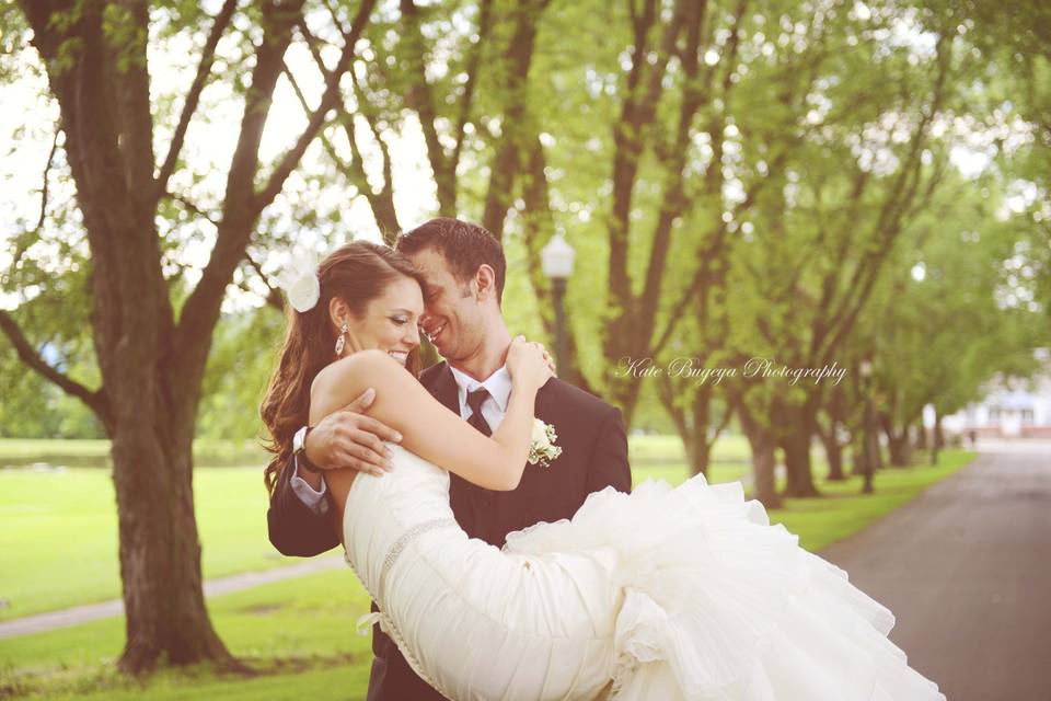 Groom carries his bride