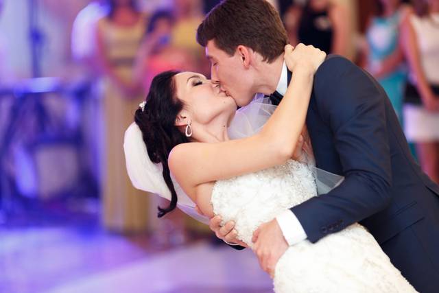 Groom dipping his bride for a kiss