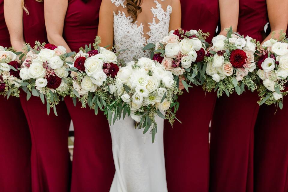 Bride and her bridesmaids in burgundy