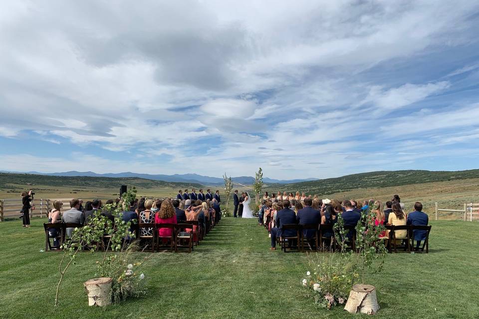 An outdoor countryside ceremony
