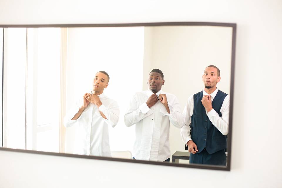 Groomsmen and groom mirror