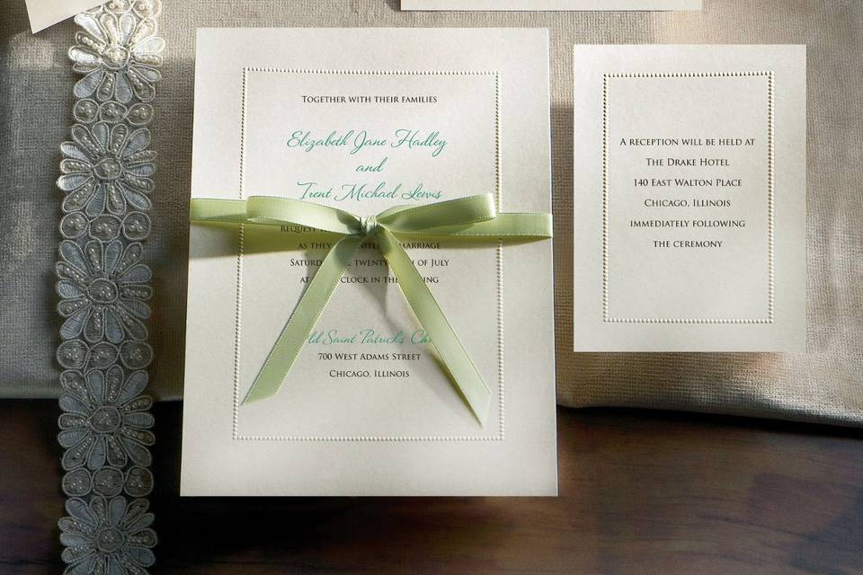 Manhattan - A perfect combination of both elegance and romance, this invitation from Exclusively Weddings  features a string of tiny embossed 