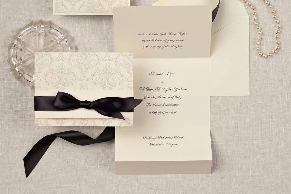 Elegant Damask - A stunning damask pattern with floral accents adorns the outside of this wedding invitation in a traditional ecru paper stock. To coordinate your wedding day theme or color, a piece of pre-cut satin ribbon is included. Also available in bright white paper stock. Order Your Free Sample Today!