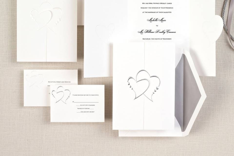 Diamond Romance - This noteworthy folded card opens to reveal your wedding invitation wording and closes with the two hearts joined together as one ... perfect symbolism for your wedding day. Available with your choice of pearl or silver accent colors. Order Your Free Sample Today!