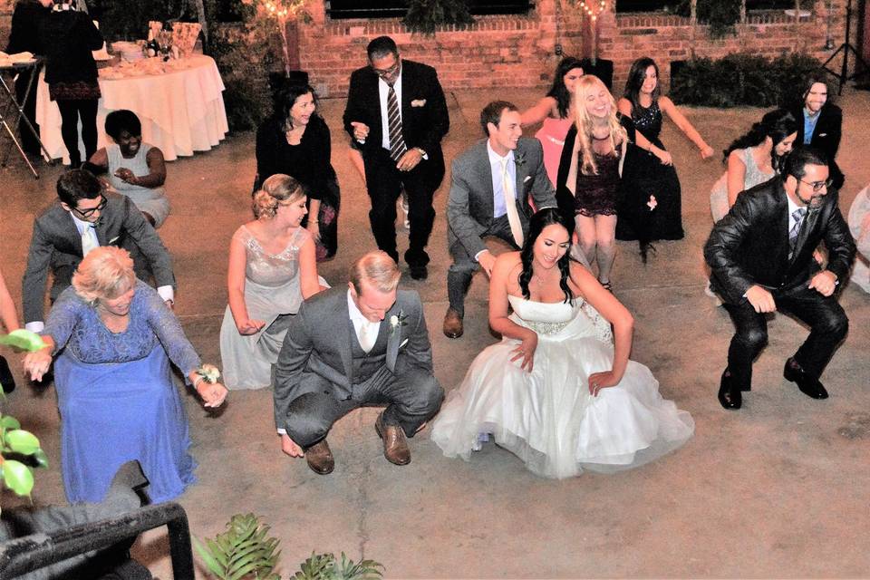 Newlyweds and guests dancing